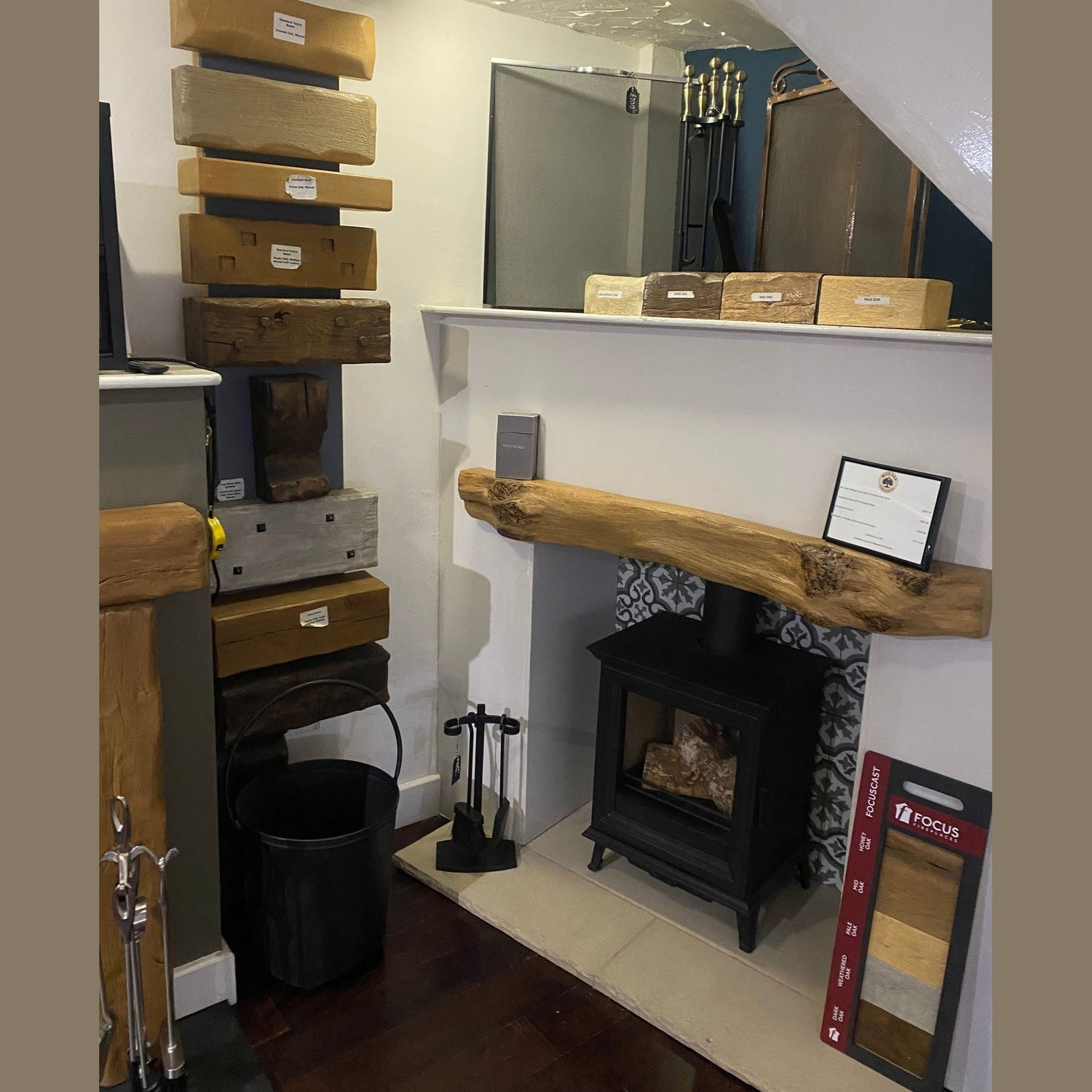Rustic floating oak effect fireplace mantel beam fixed above a traditional stove hearth.