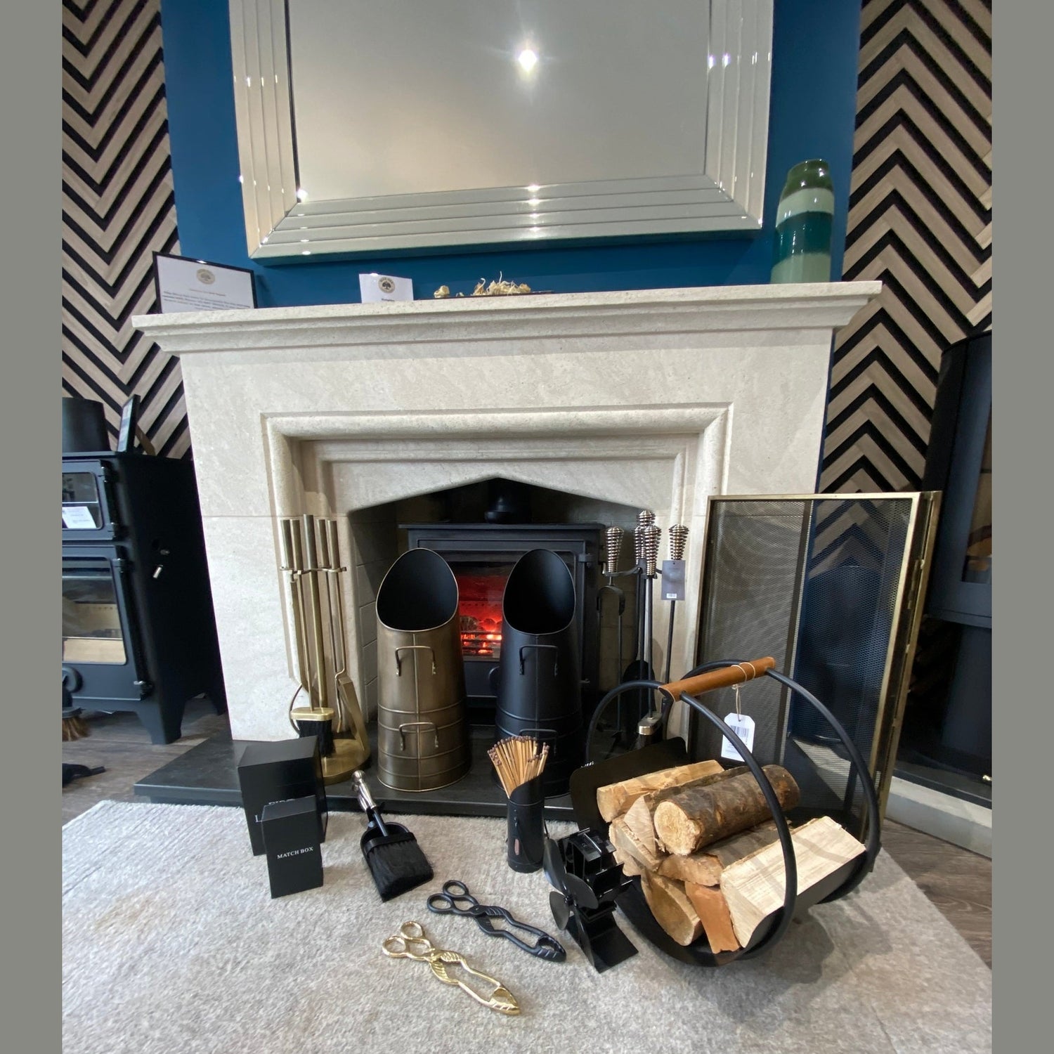 Luxury fireside accessories collection featuring brass companion sets, black coal buckets, fire screens, and a log basket, leicester