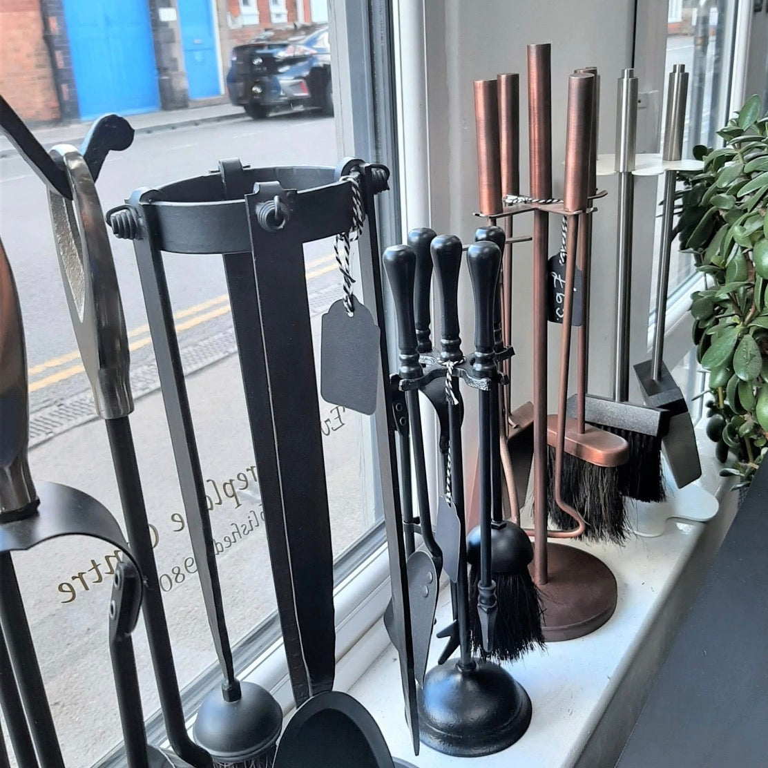 Fireside companion sets in matte black, antique pewter, and brushed copper finishes.
