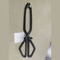 Closed black cast iron fireplace tongs with diamond handle openings