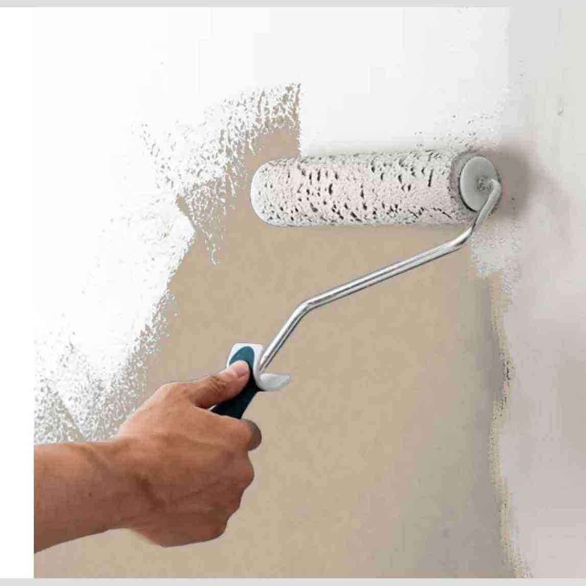 Hand painting unfinished beige MDF media wall panel with white paint roller
