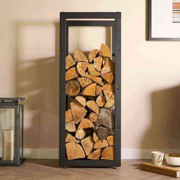 Tall black metal log rack filled with neatly stacked firewood, designed for indoor fireside use, SKU: 26857