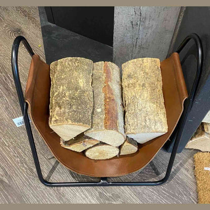 Top view of Apache brown leather log storage basket filled with stacked wood logs