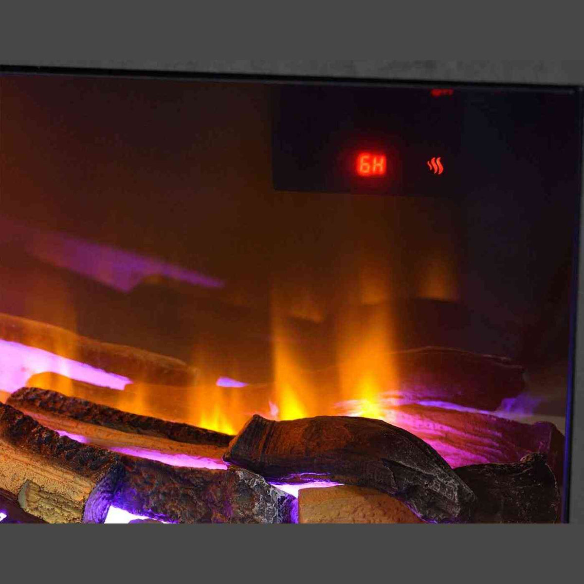 Interior close-up of Aurora Aries electric fire showing glowing logs on reflective crystals with digital timer display and ambient lighting