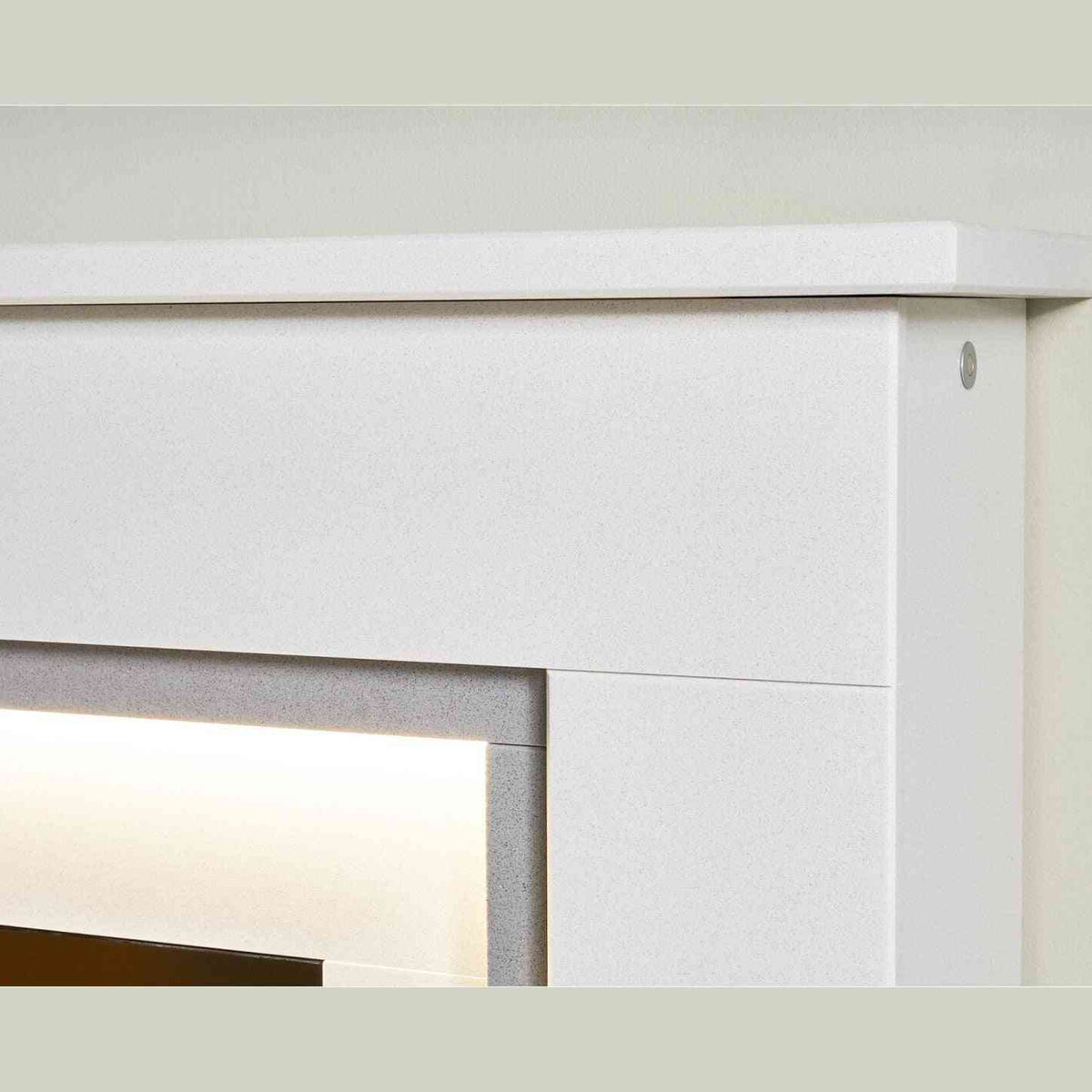 Detail shot of white speckled mantel and integrated warm white LED ambient light strip on fireplace suite