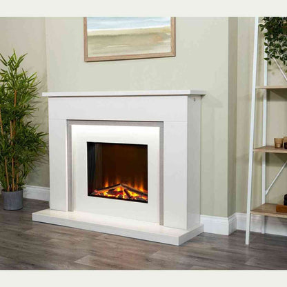 Three-quarter view of white marble electric fireplace suite with grey vertical accents in modern living room