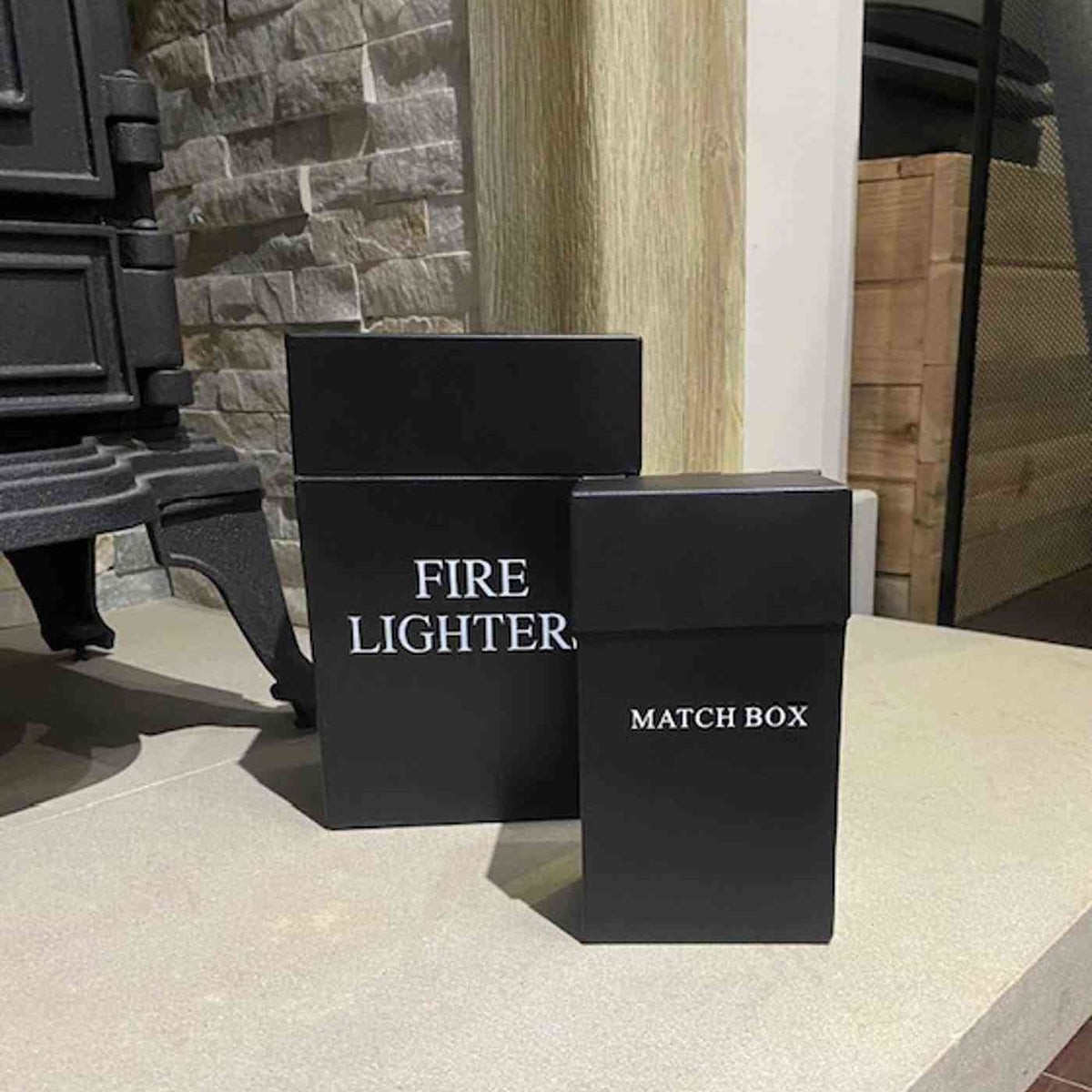 Closed matte black fireplace storage set with white lettering for logs and matches