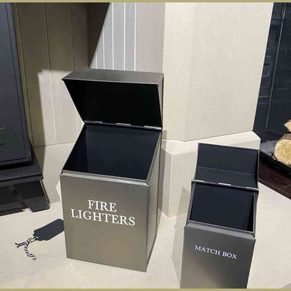 Open brushed silver fire lighters and match box holders revealing black interiors