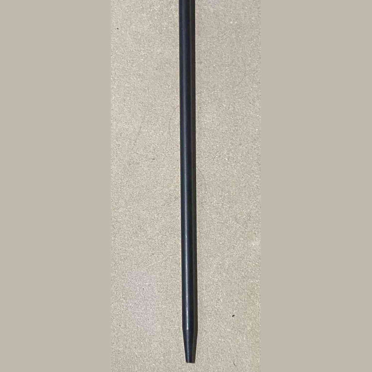 Matte black tapered tip of heavy duty cast iron fire poker for wood burner