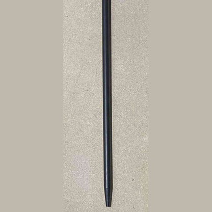 Matte black tapered tip of heavy duty cast iron fire poker for wood burner