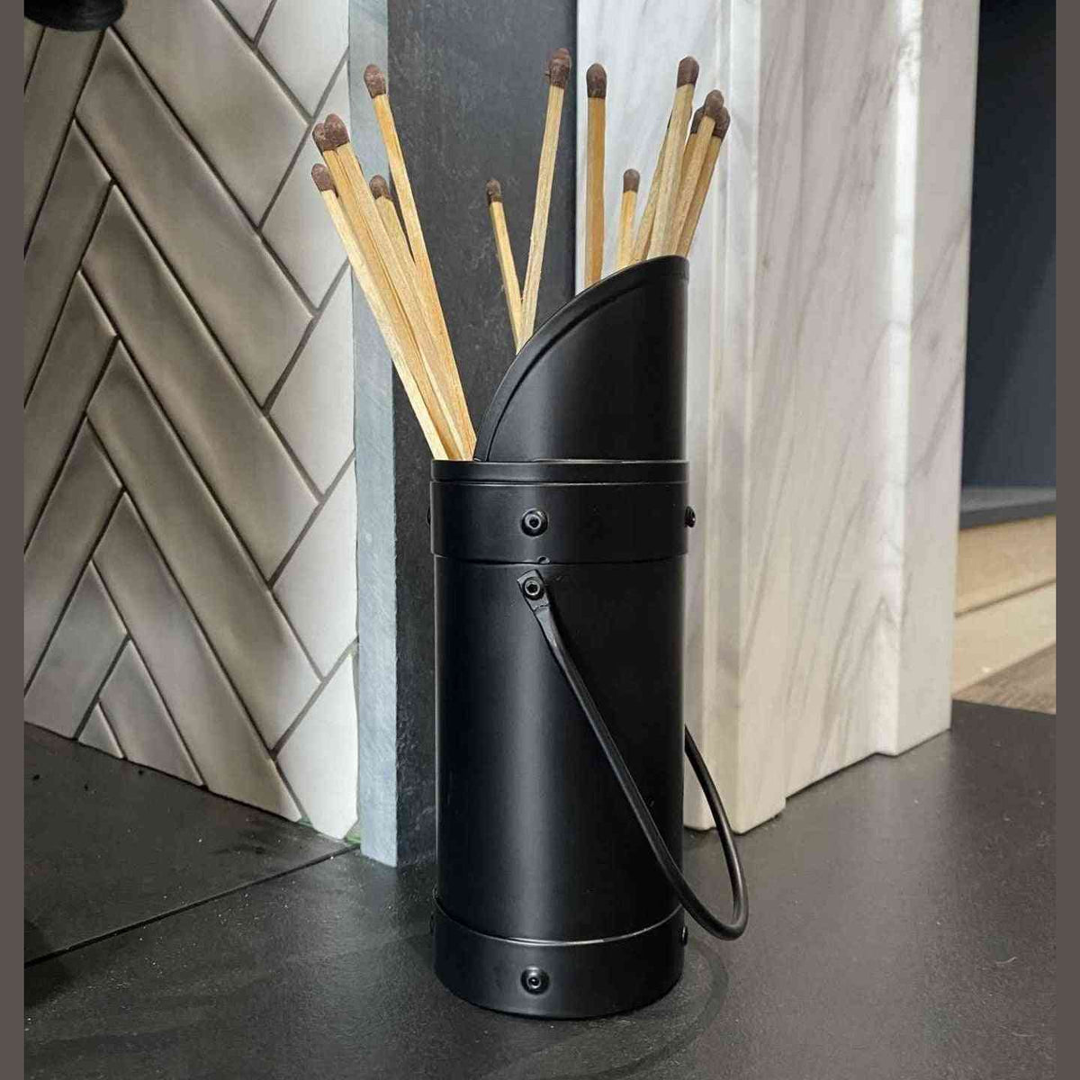 Close-up of black Calfire match holder window showing brown interior and long matches
