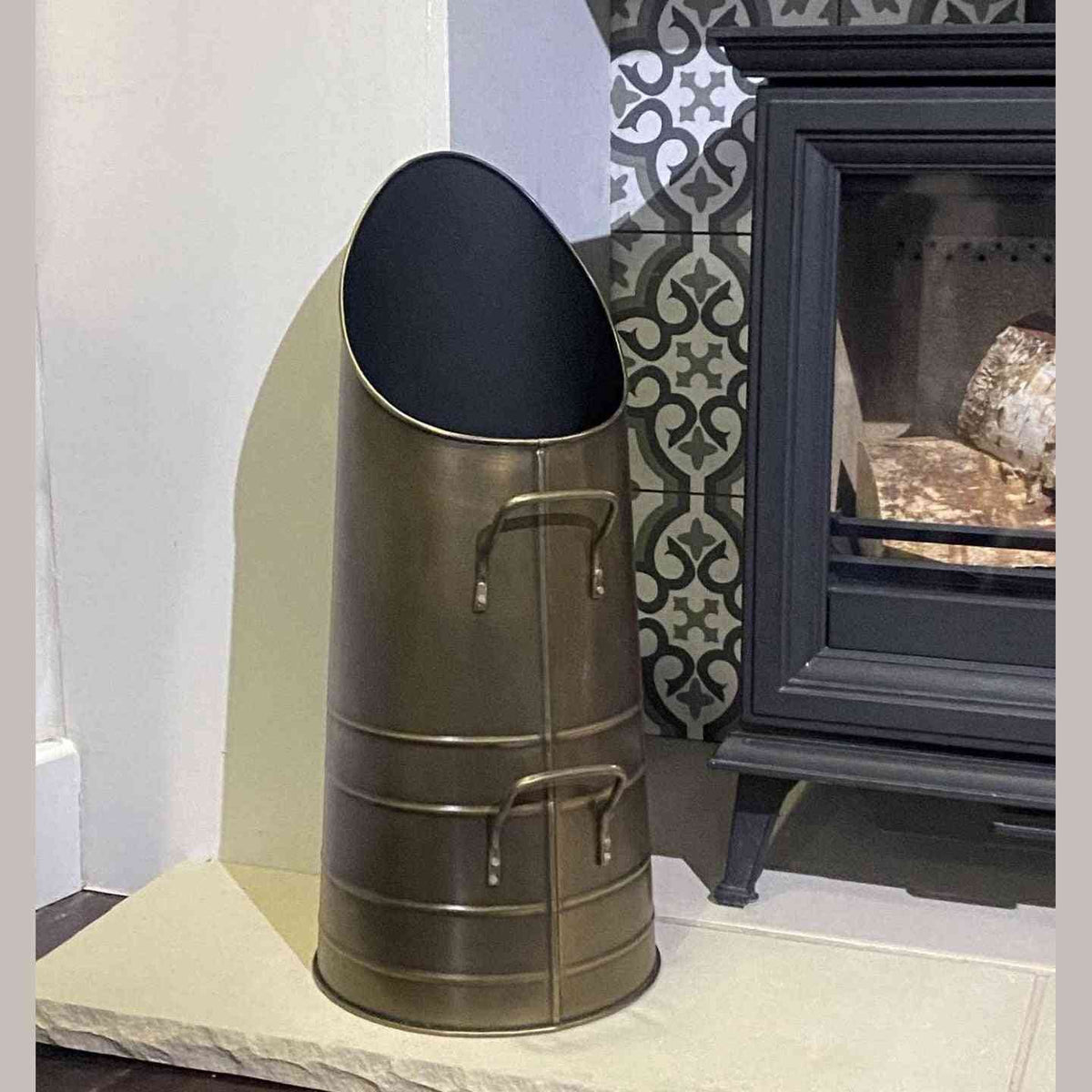 Calfire Dryton antique pewter coal scuttle on stone hearth with wood stove