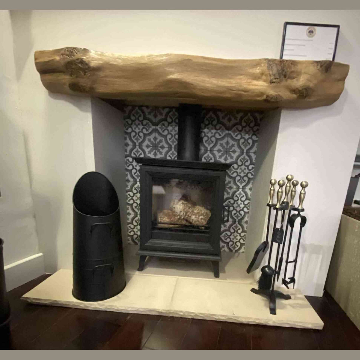 Full view of black Calfire coal bucket in traditional fireplace setting