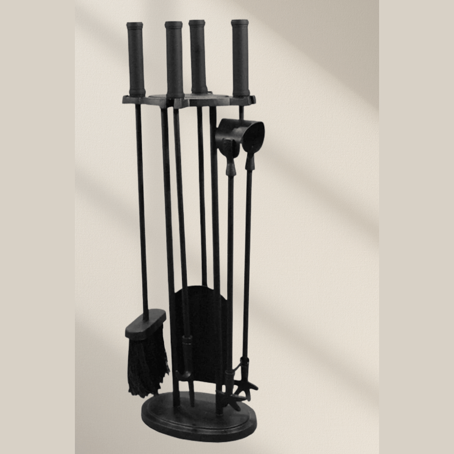 Black iron fireplace companion set with star-tipped tongs and cylindrical handles