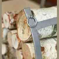 Close-up of Antique Pewter log rack holding firewood with circular ring detail