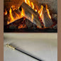 Black cast iron fireplace poker near active electric fireplace with flames