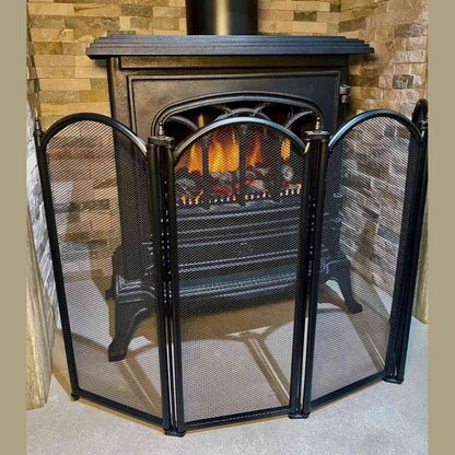 Matte black 4-fold fire guard screen protecting wood-burning stove from sparks