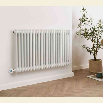 White wall-mounted electric radiator showing blue LCD digital thermostat display