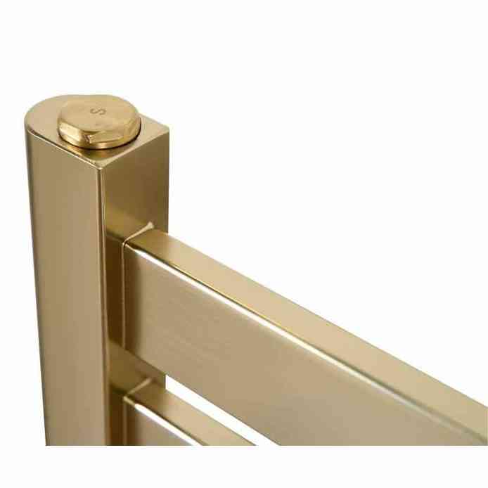 Close-up of brushed brass top corner detail with engraved S cap on Eden towel radiator