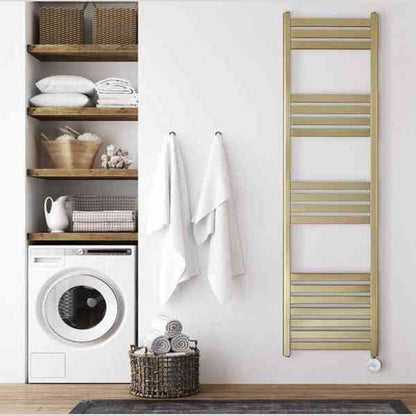Brushed brass Eden Caldera tall electric towel radiator mounted in modern bathroom with towels