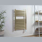 Brushed brass smart bathroom heater mounted on grey wall with towels nearby