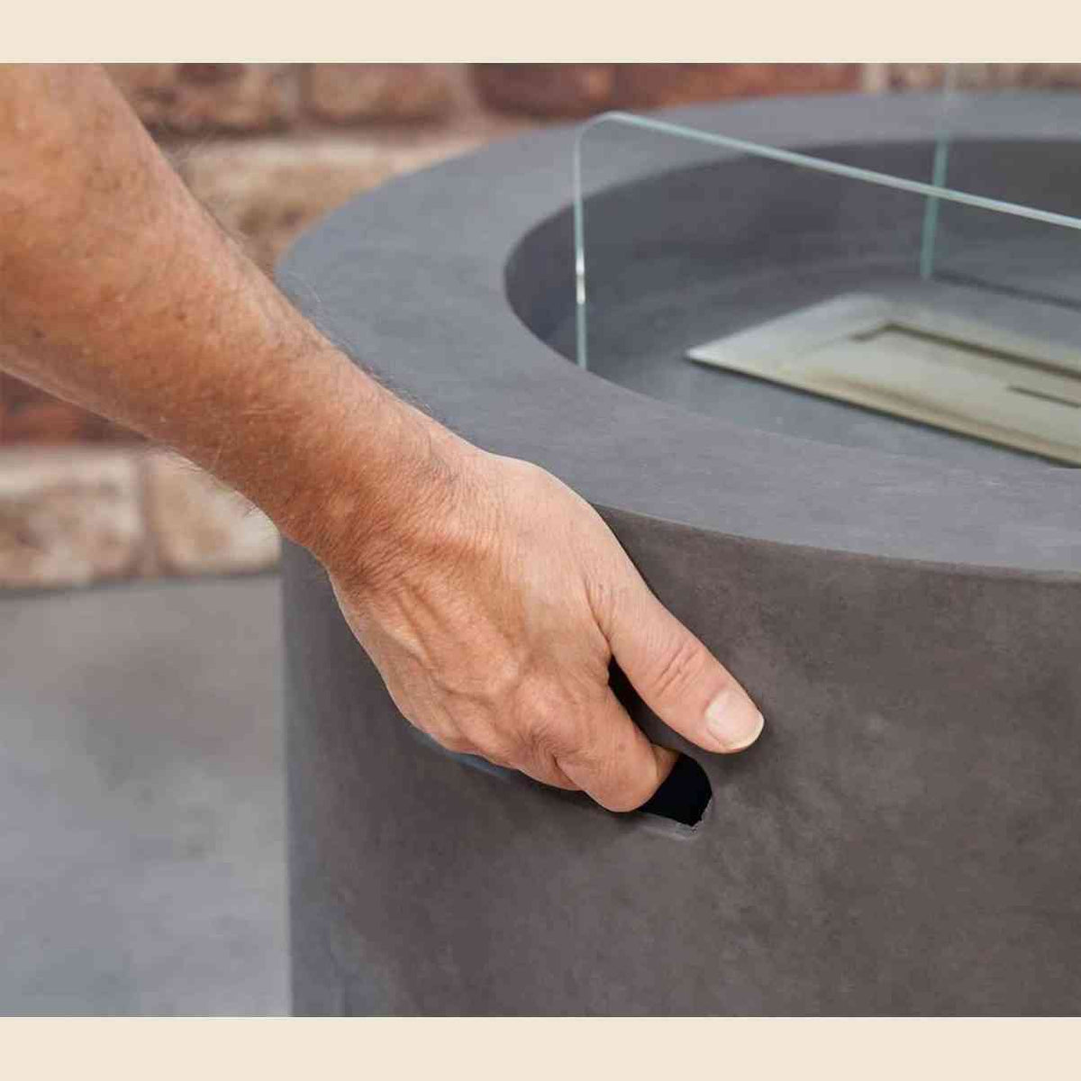 Close-up of recessed handle on Field & Flame dark concrete grey outdoor fire pit showing textured matte finish
