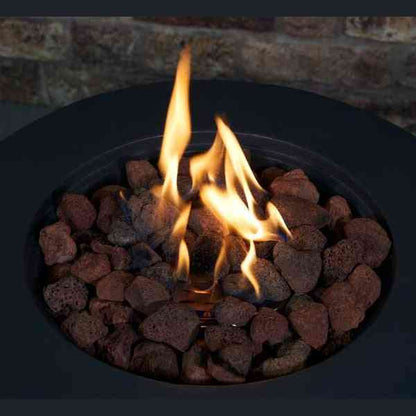 Close-up of orange flames rising from reddish-brown lava rocks inside grey fire pit basin