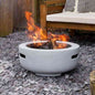 Outdoor concrete grey fire pit in use on gravel patio near wooden bench