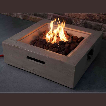 Side angle of lit square concrete fire pit with handle cutout and control knob
