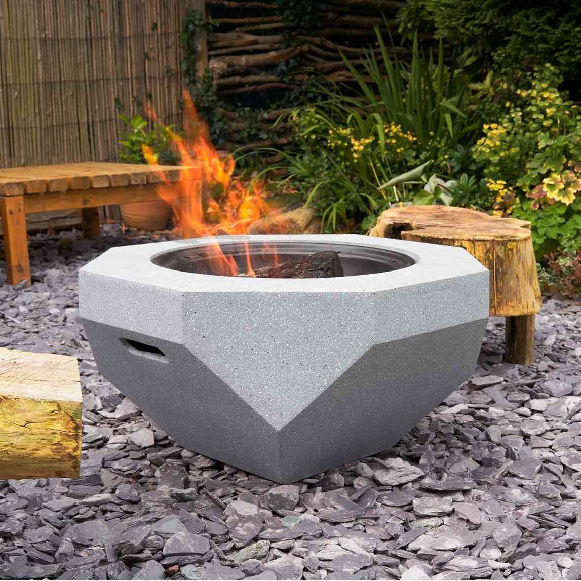 Octagonal wood burning BBQ fire pit with active flames outdoors
