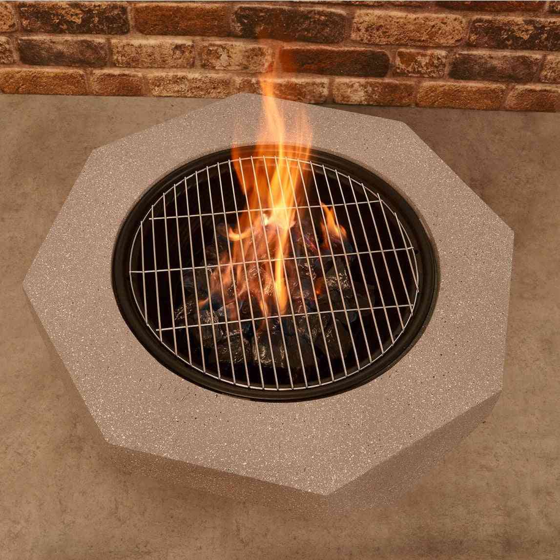 Fire pit with metal grill grate for outdoor cooking over embers
