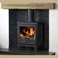 Full view of Geocast oak effect mantel beam on slate surround with active fire