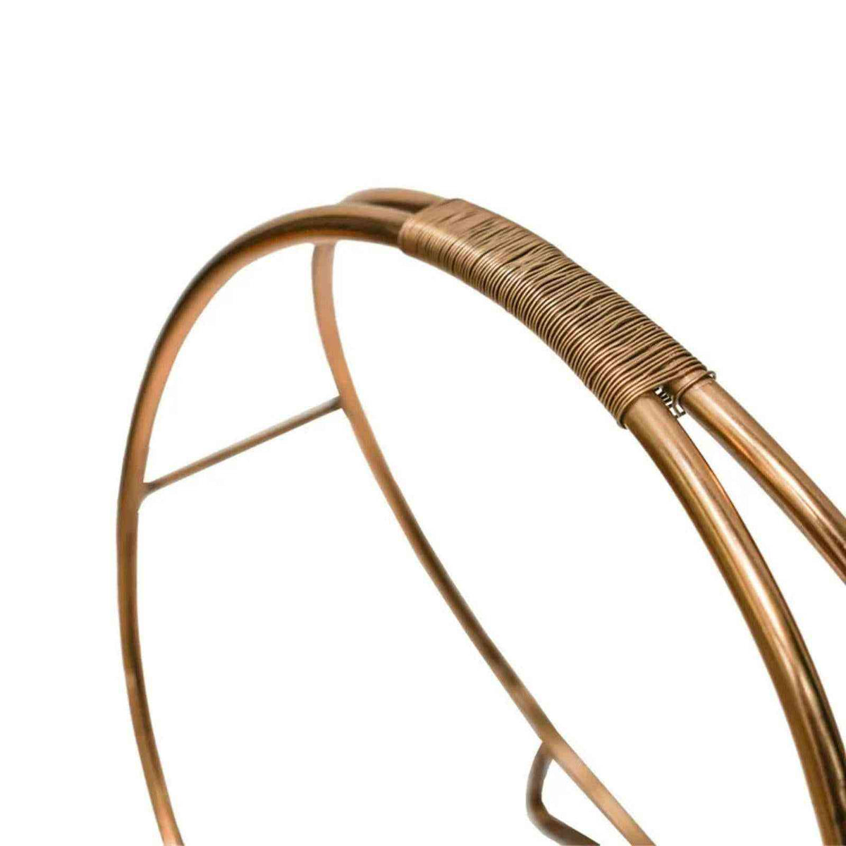 Close-up of textured wire-wrapped handle on copper log rack