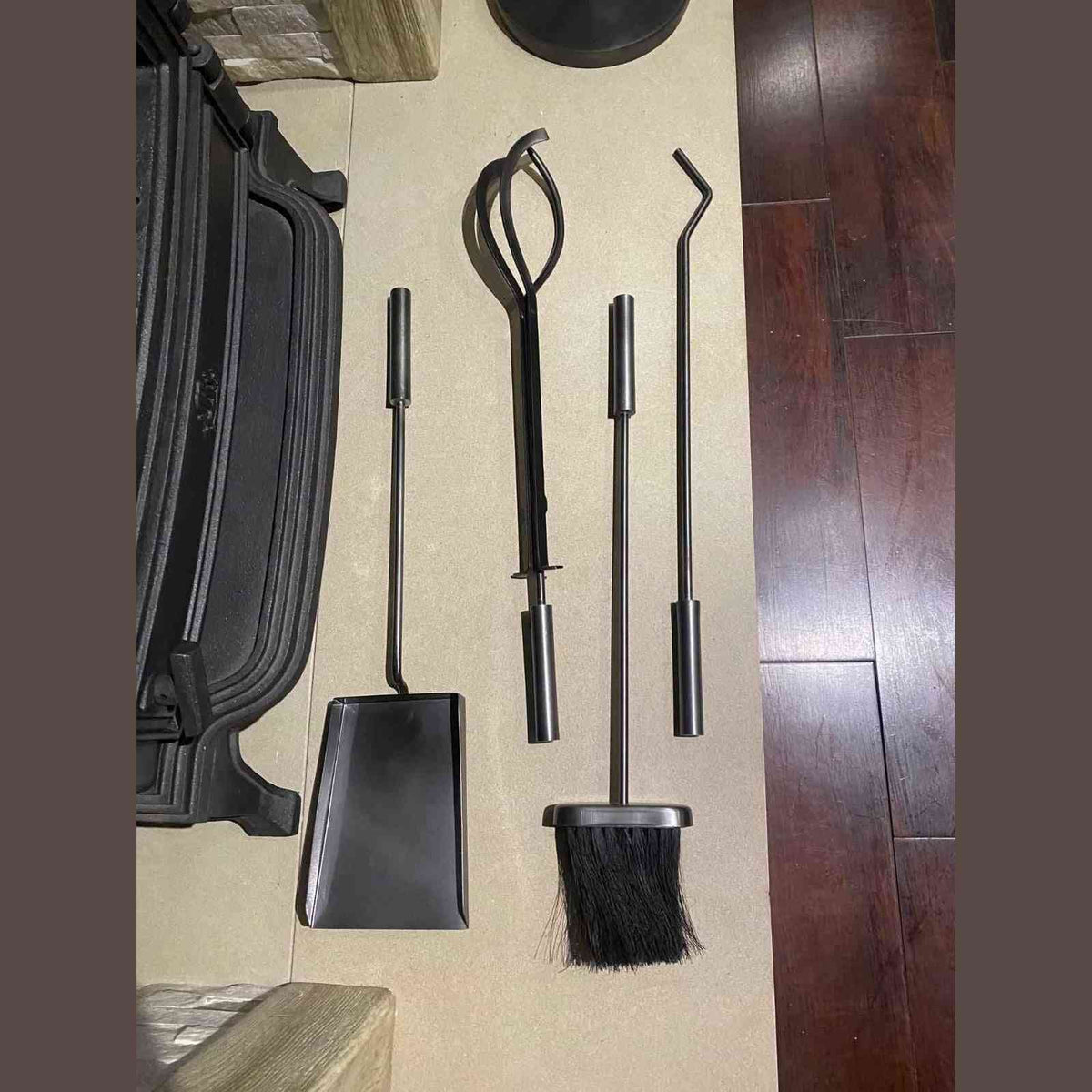 Galvanised steel 4-piece fireplace tool set with shovel, tongs, poker and brush on floor
