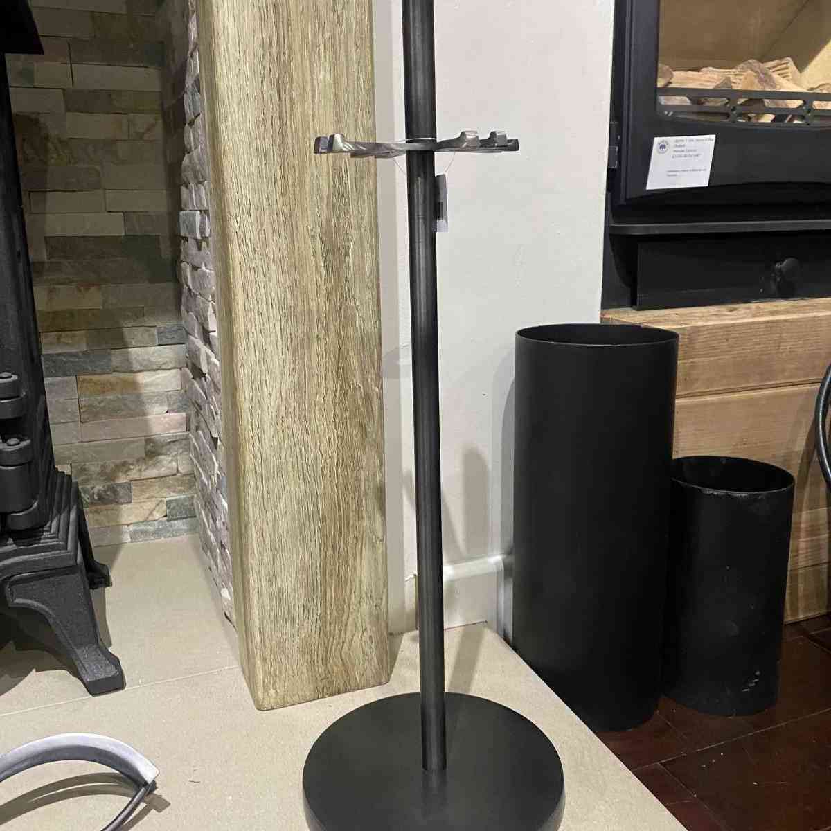 Top-down detail of empty circular stand for 4-piece fireplace tool kit