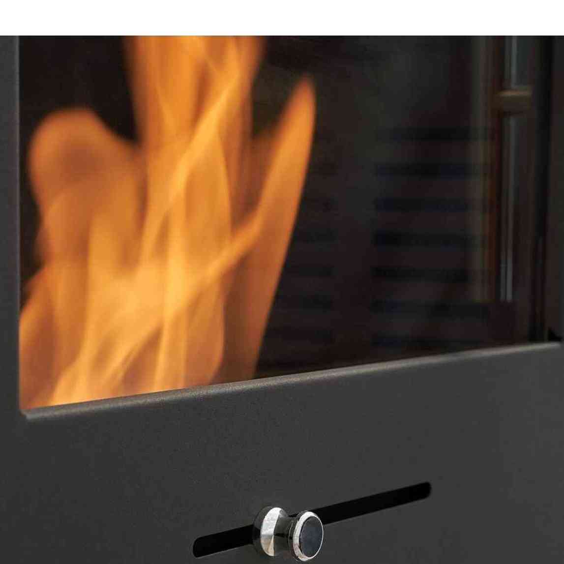 Close-up of charcoal grey ethanol fireplace control knob and glass flame panel