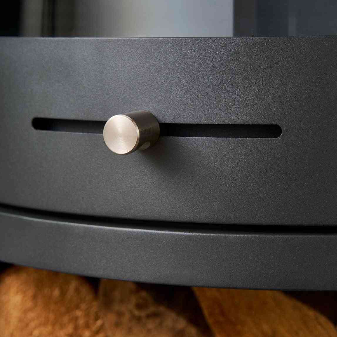 Cylindrical brushed metal control knob on textured matte front panel of charcoal grey OKO S5 ethanol fireplace