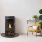 Full view of charcoal grey OKO S5 bio ethanol stove with glass front flame and log storage in modern living room