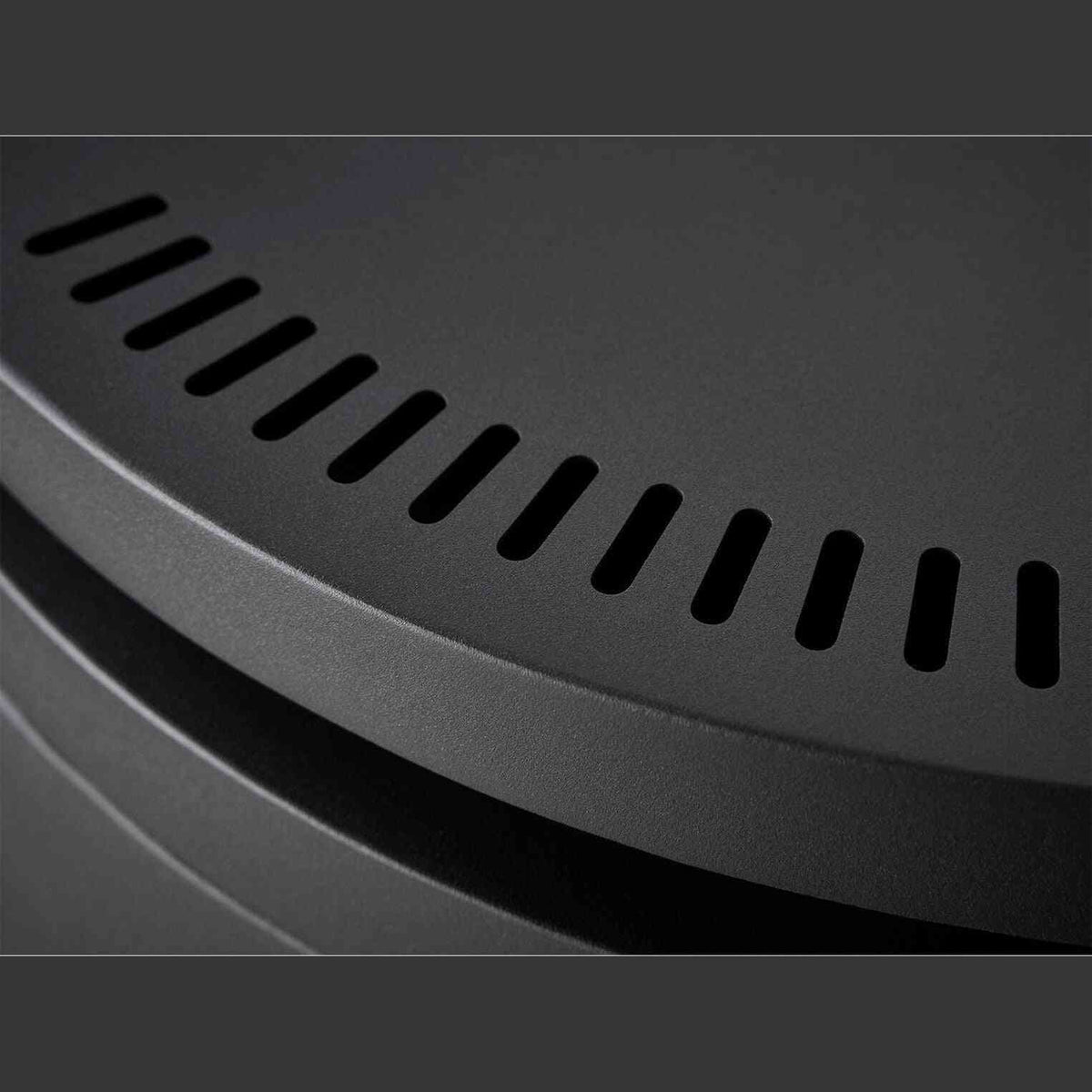 Close-up of charcoal grey matte metal ventilation slots and curved ridge detail on OKO S5 freestanding fireplace
