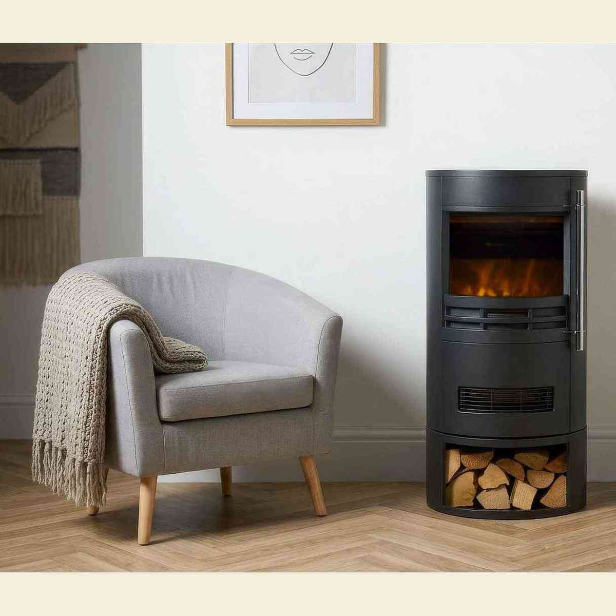 Black cylindrical electric fireplace in modern living room with lit LED flame