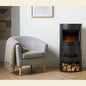 Black cylindrical electric fireplace in modern living room with lit LED flame