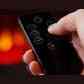 Hand holding remote control for Sureflame electric fireplace