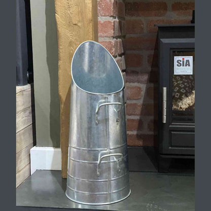Side angle of galvanized zinc fireplace coal storage bucket