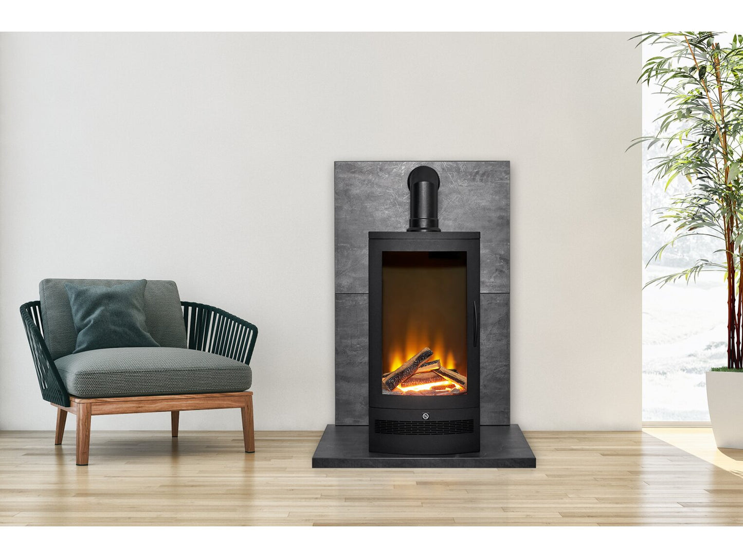 Aurora Delta freestanding modern electric stove styled against a slate back panel in a bright living room next to a teal accent armchair.
