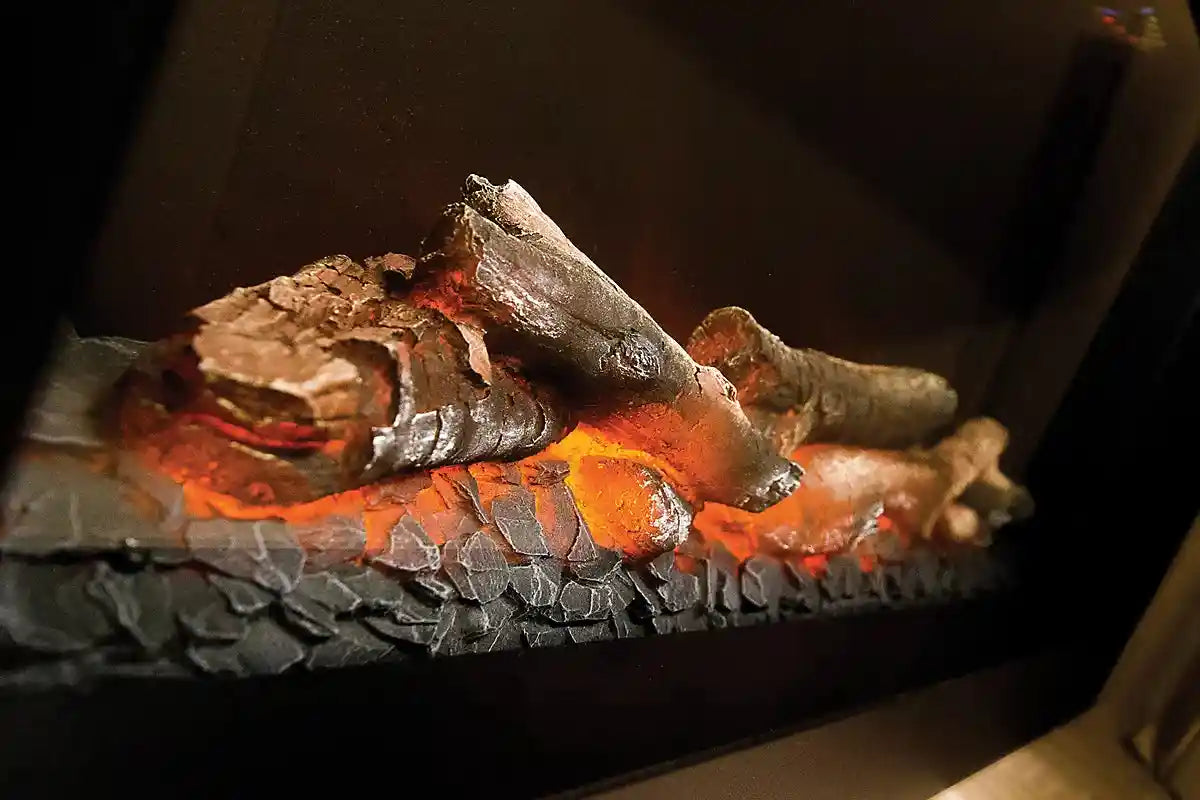Close-up of realistic electric fireplace with glowing embers and ceramic logs, designed for indoor home heating and modern living spaces