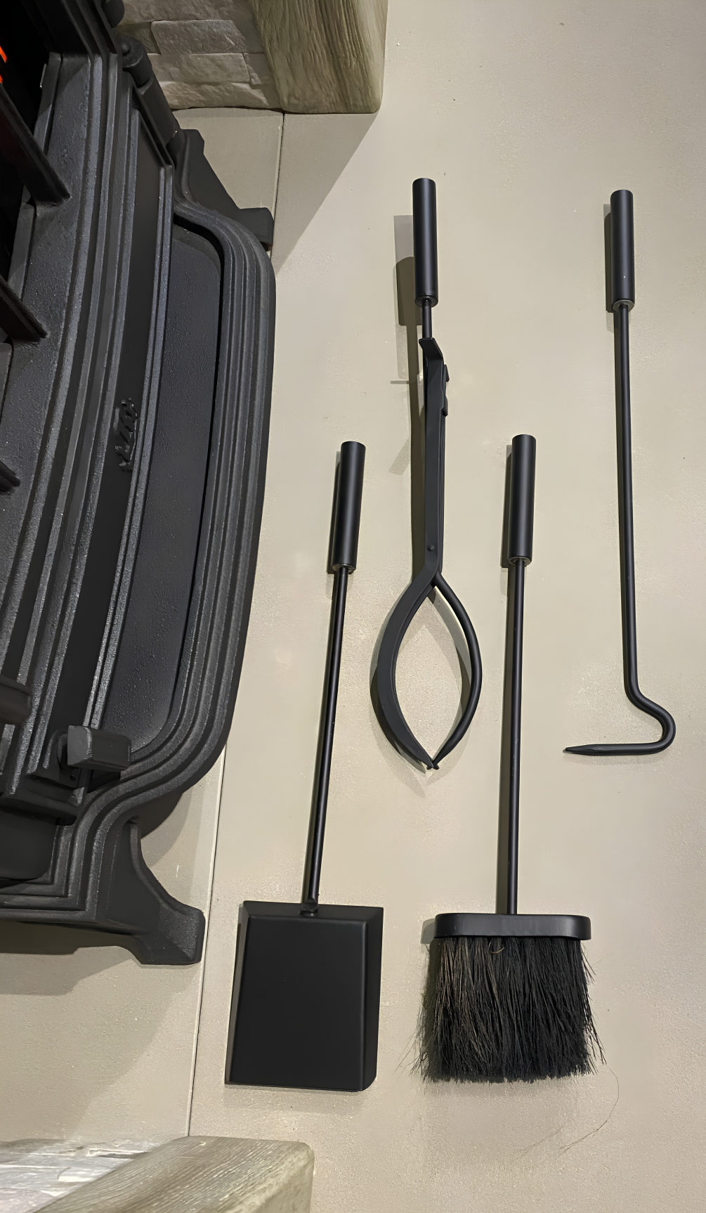 Individual pieces of the Calfire Burlton 27149 set laid out separately to show the high-temperature shovel, stove brush, long poker, and log tongs.