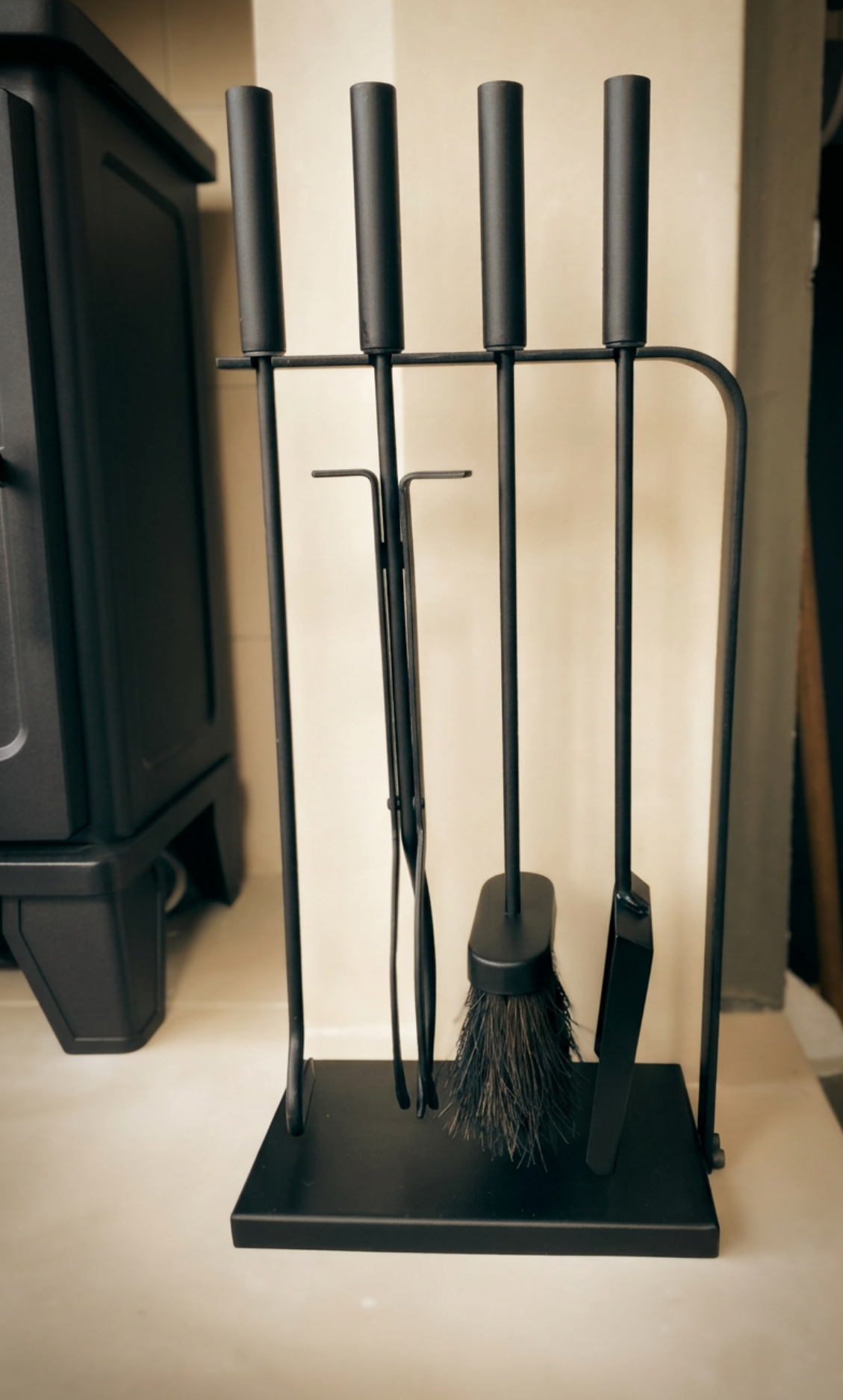 Full-length view of the 510mm modern black fire companion tools arranged on their organizer stand next to a traditional fireplace hearth.