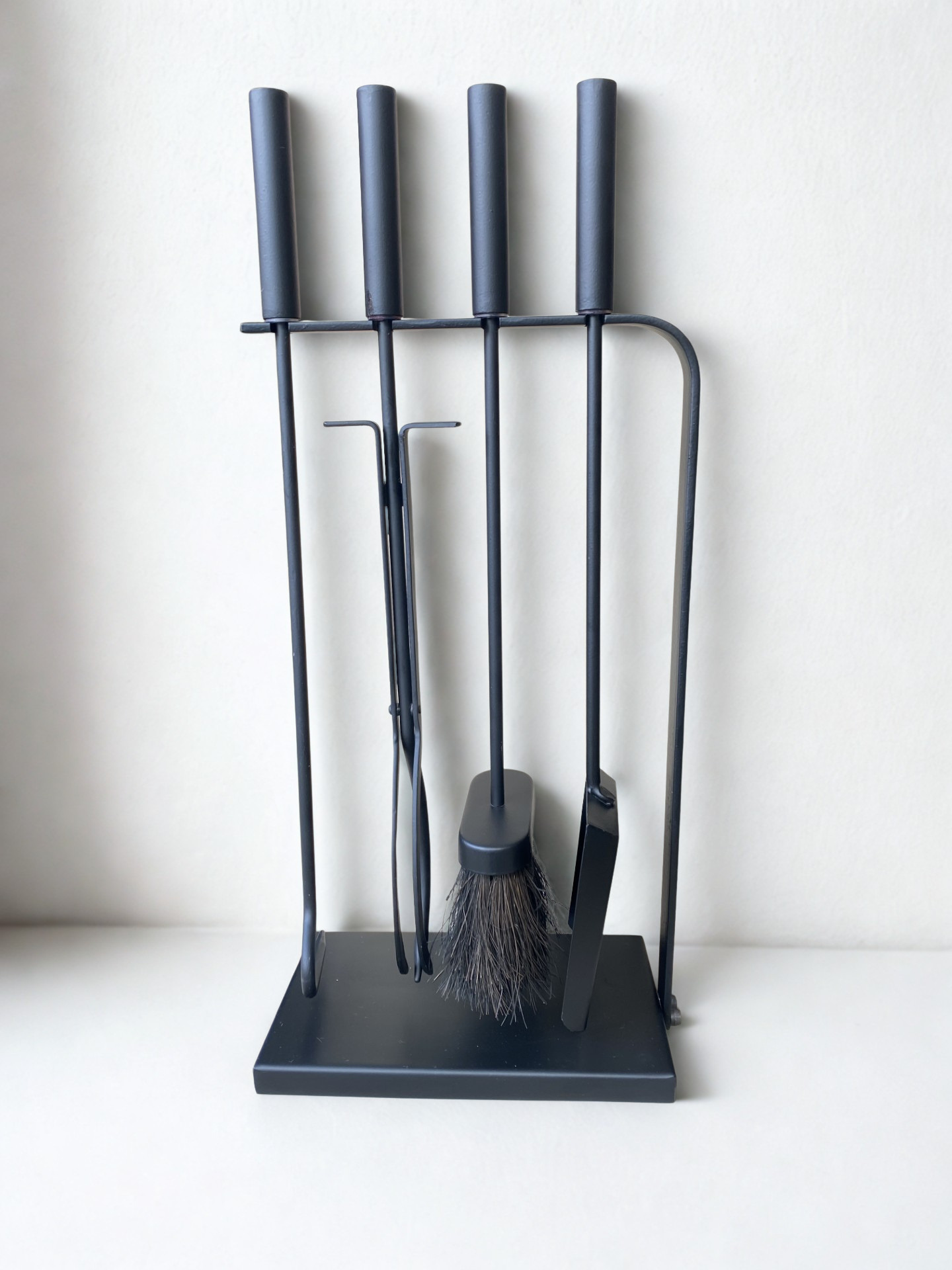 Calfire Burlton Black Companion Set 27149 - 510mm modern hearth tool set with shovel, brush, poker, and tongs standing on a sleek rectangular base against a white wall.