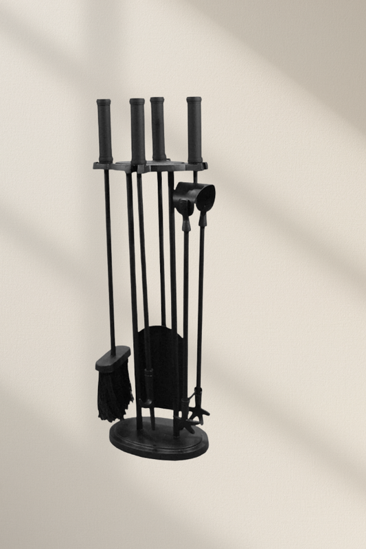 A matte black contemporary fireplace companion tool set featuring clean-lined cylindrical handles on a space-saving round base with four hanging fire tools.