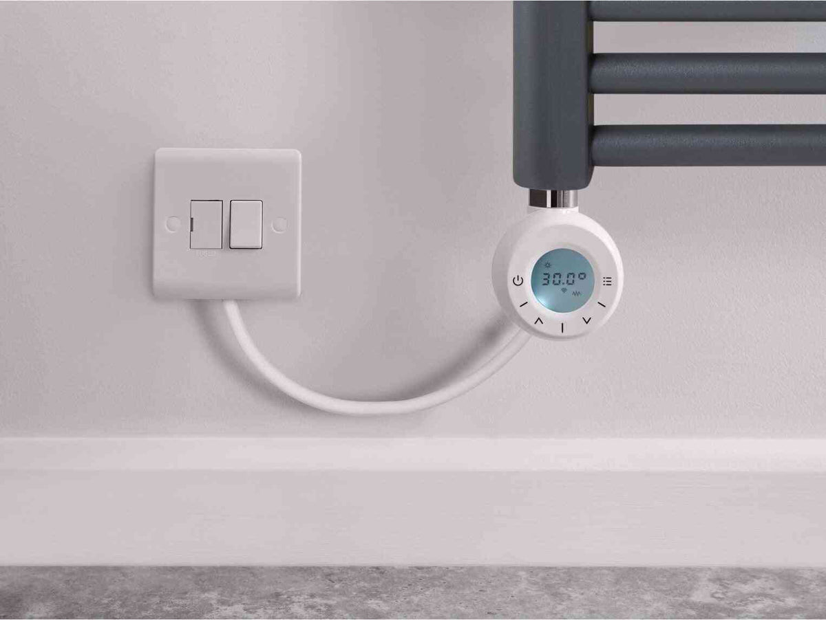 White electrical outlet with two switches and a connected smart digital thermostat displaying 30.0°C, mounted on a light gray wall